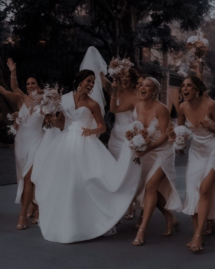 a group of women in white dresses